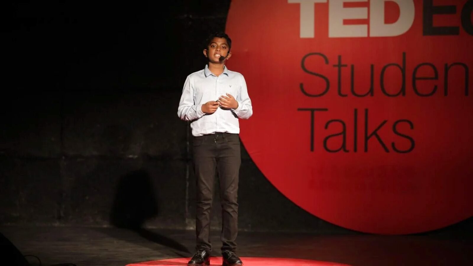 A student speaking on the TED-Ed Student Talks stage.