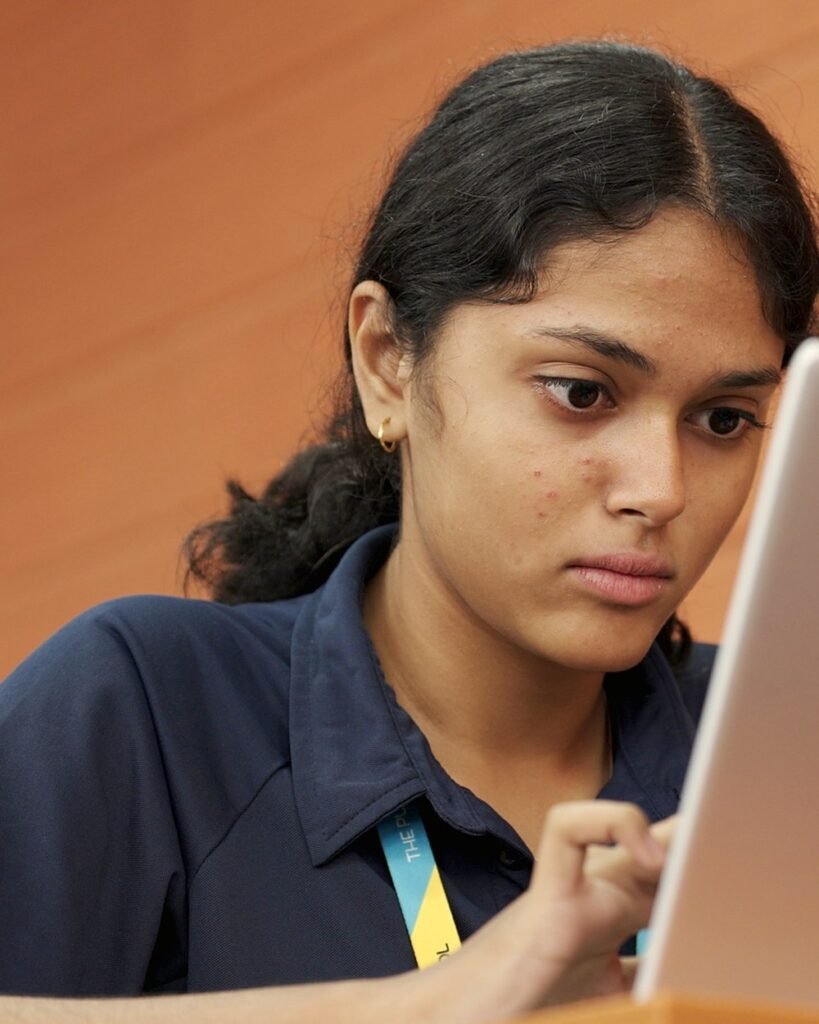 A student working at a laptop.