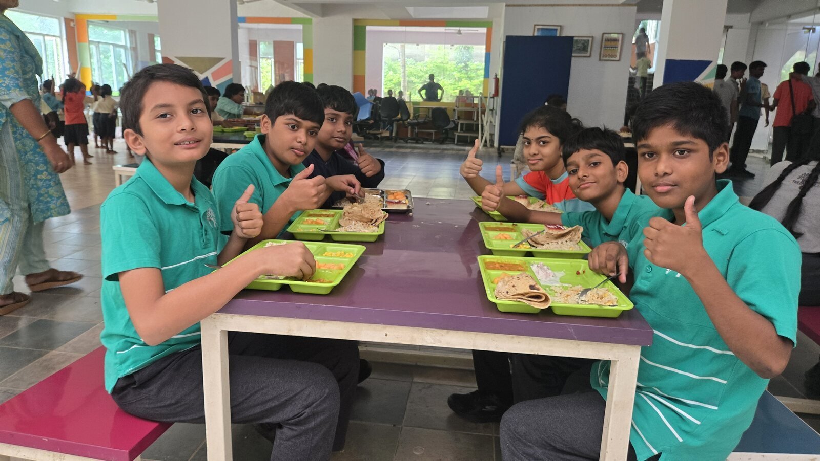Students giving a thumbs up over lunch at KCal.