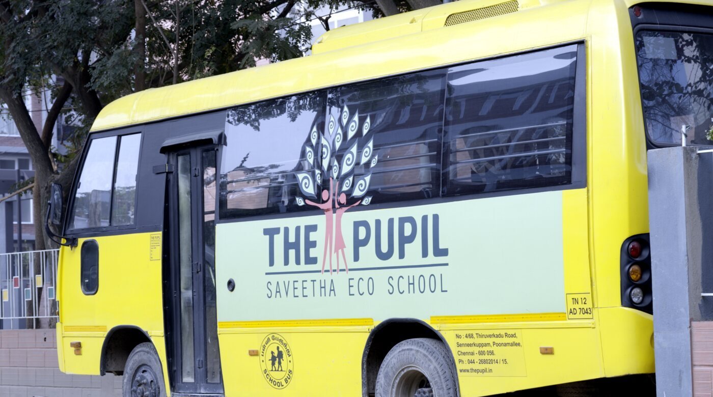 A yellow school bus parked at the school.