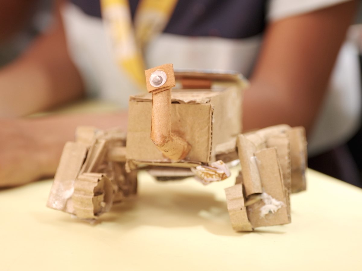 A small walking creature made from cardboard.