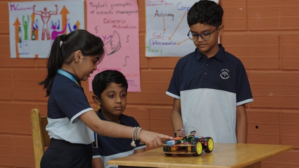 Students collaborating to test a model robot.