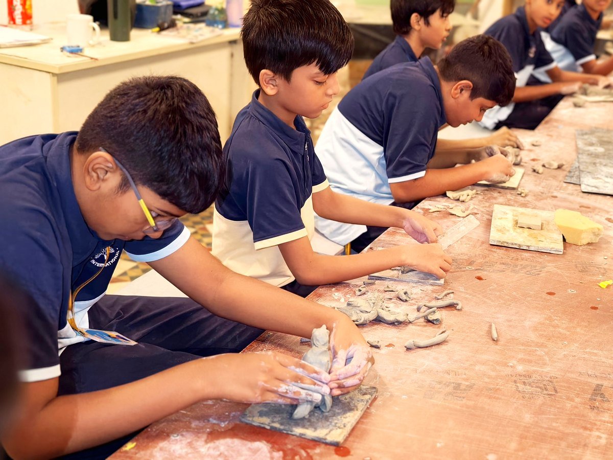 Students shaping clay models in the art room.