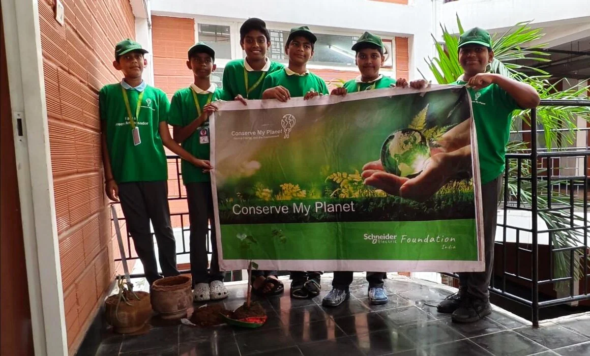 Eco Warriors students holding up their Conserve My Planet banner.