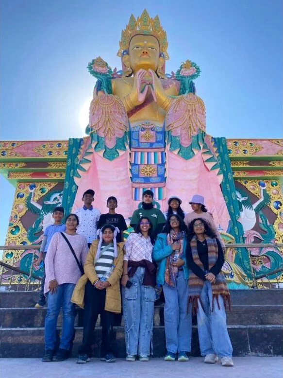 Heritage Club students under the Maitreya Buddha statue at Diskit Monastery, Ladakh.