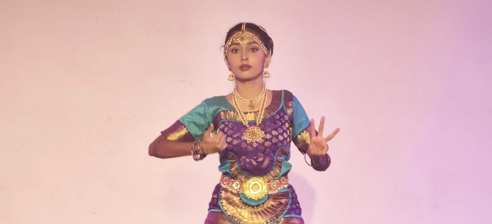A Bharatanatyam dancer showing a hand gesture with focus.