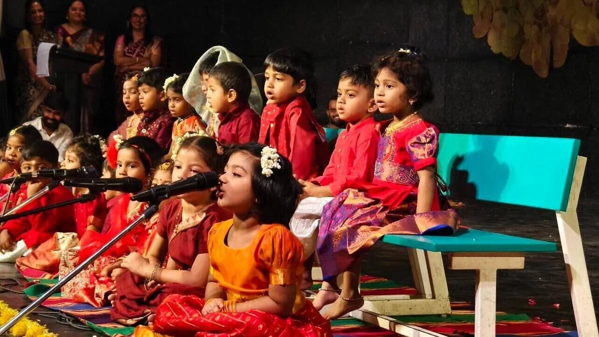 Young students singing together at Margazhi Mahotsav.