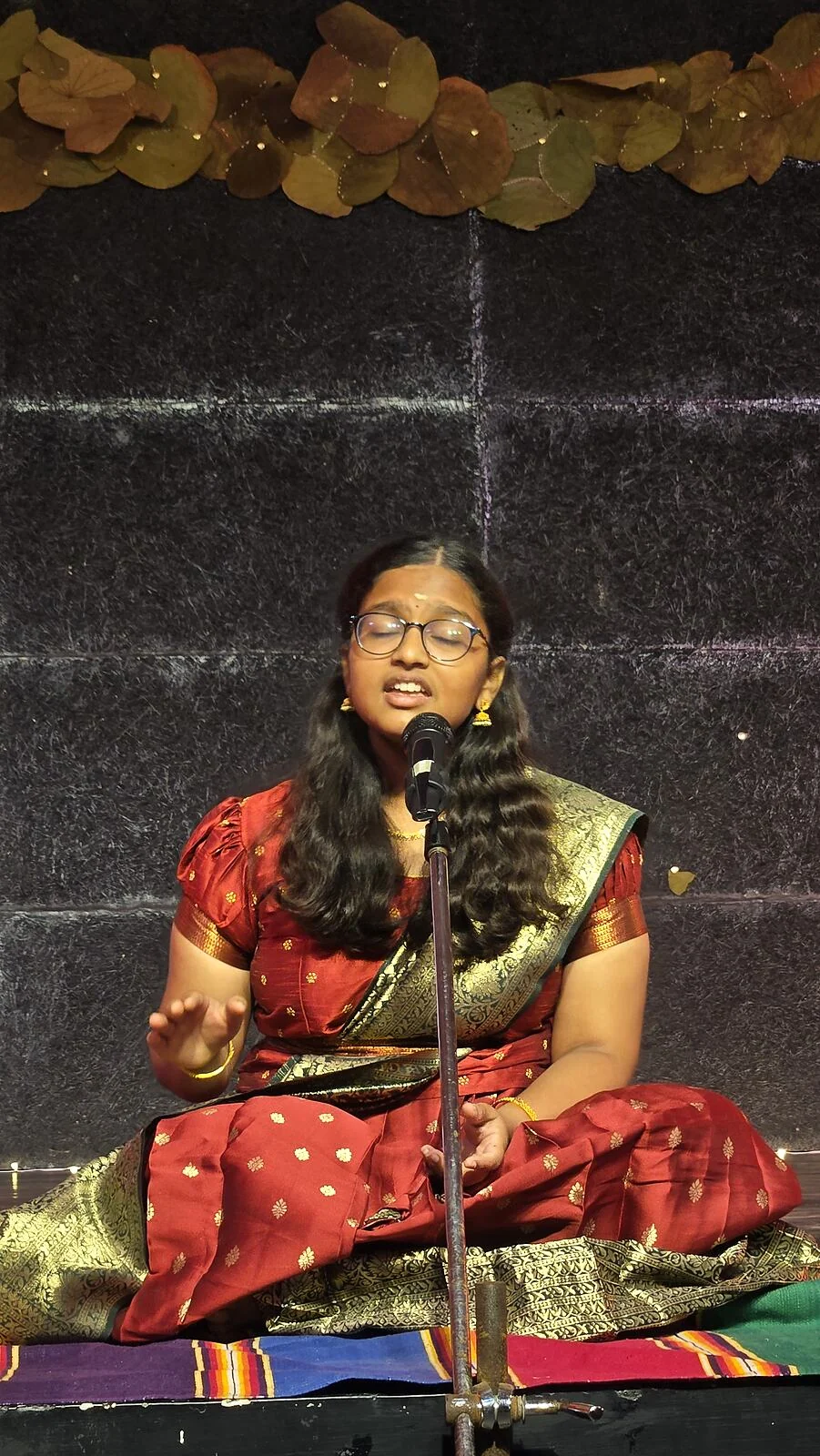 A student singing into a microphone.