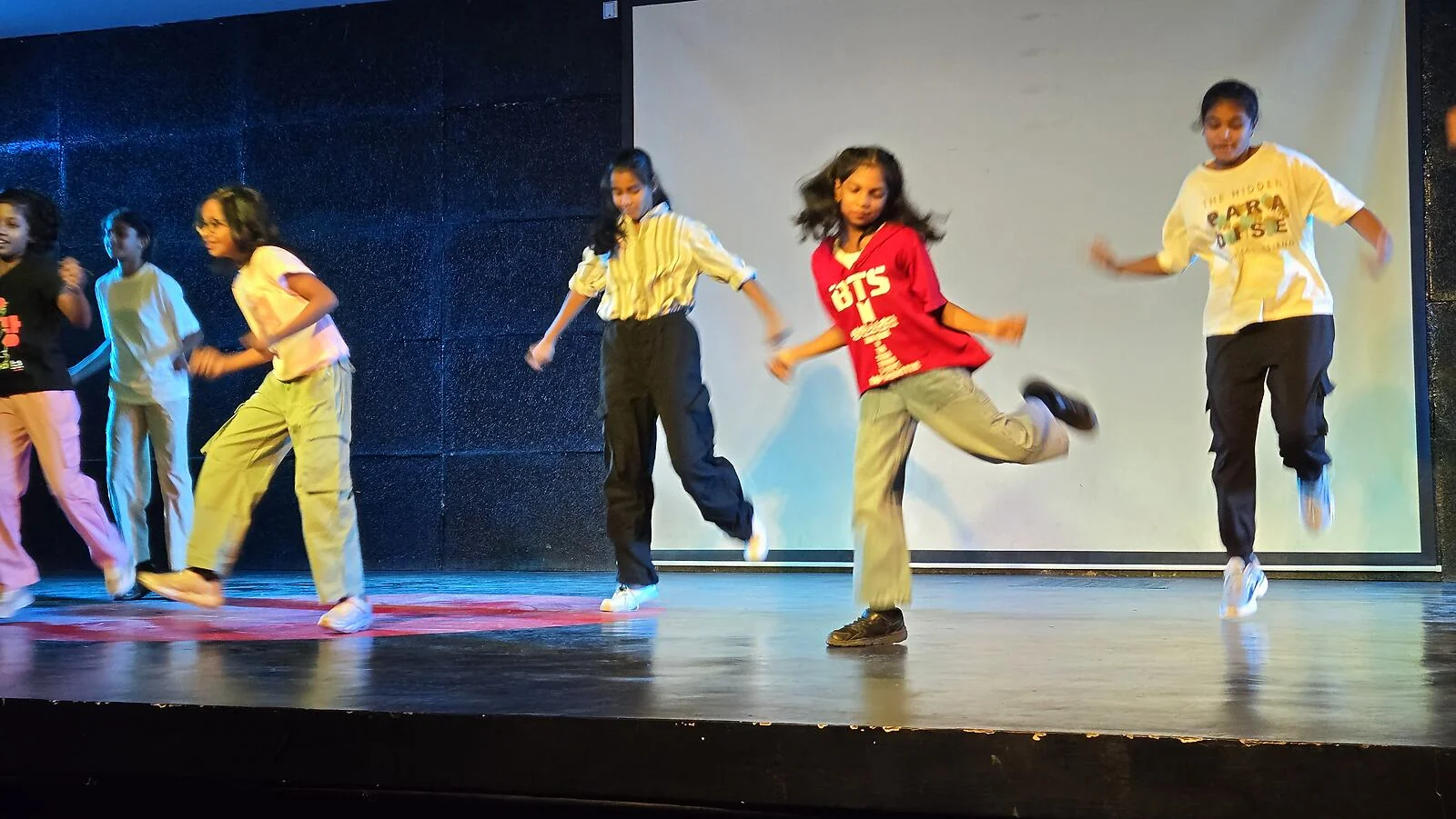 Students performing an energetic western dance routine.