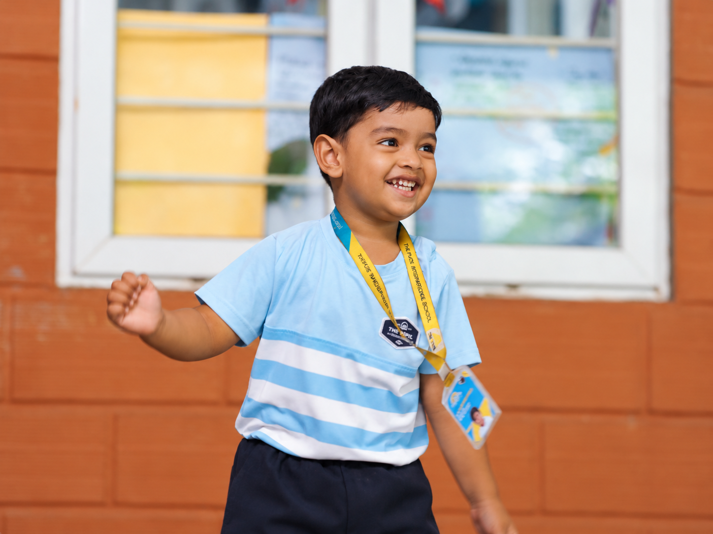 Early years student smiling during a movement activity at The Pupil International School
